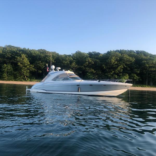 Formula 400 Super Sport 2008 Formula 400 Super Sport yacht on calm water near a forested shoreline.