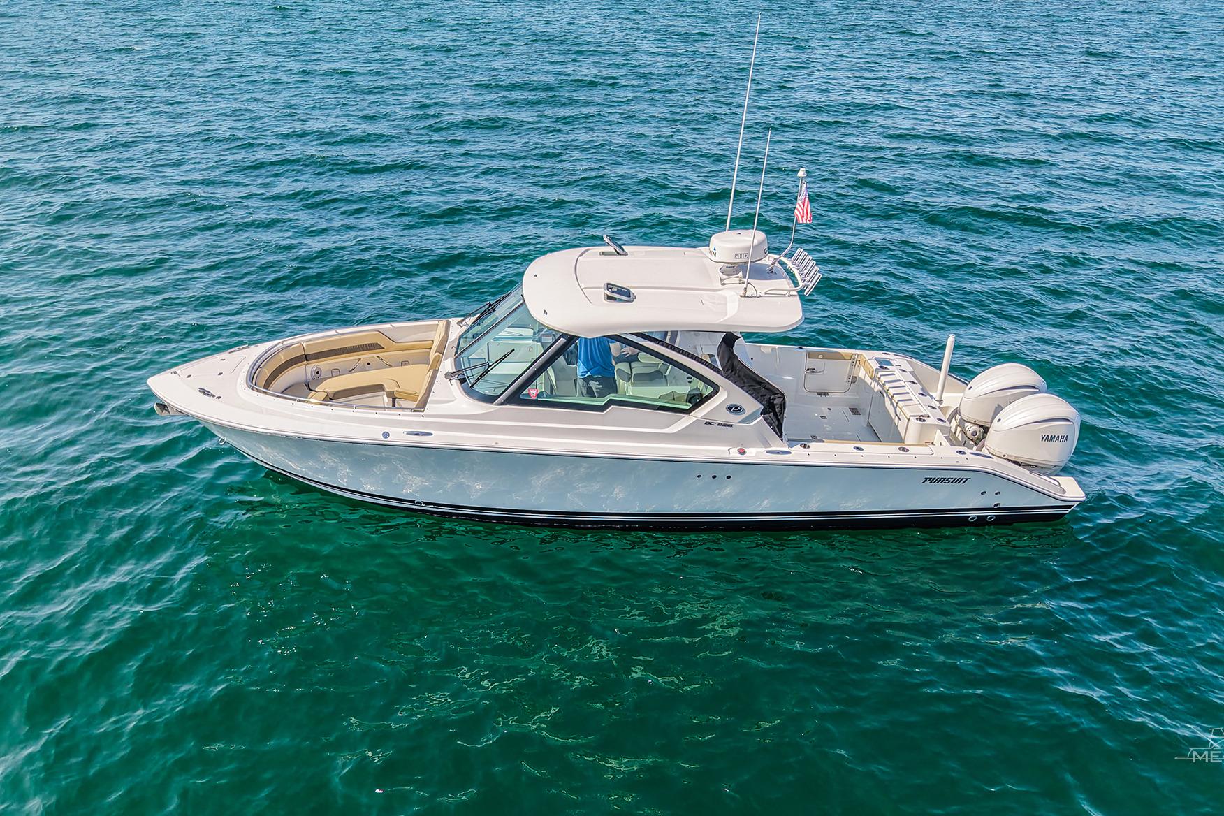 Pursuit DC 326 Dual Console 2021 Pursuit DC 326 Dual Console boat on open water, side view.