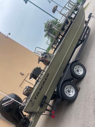 Tracker Grizzly 2072 CC Sportsman 2024 Tracker Grizzly 2072 CC Sportsman boat on trailer with Mercury outboard motor.