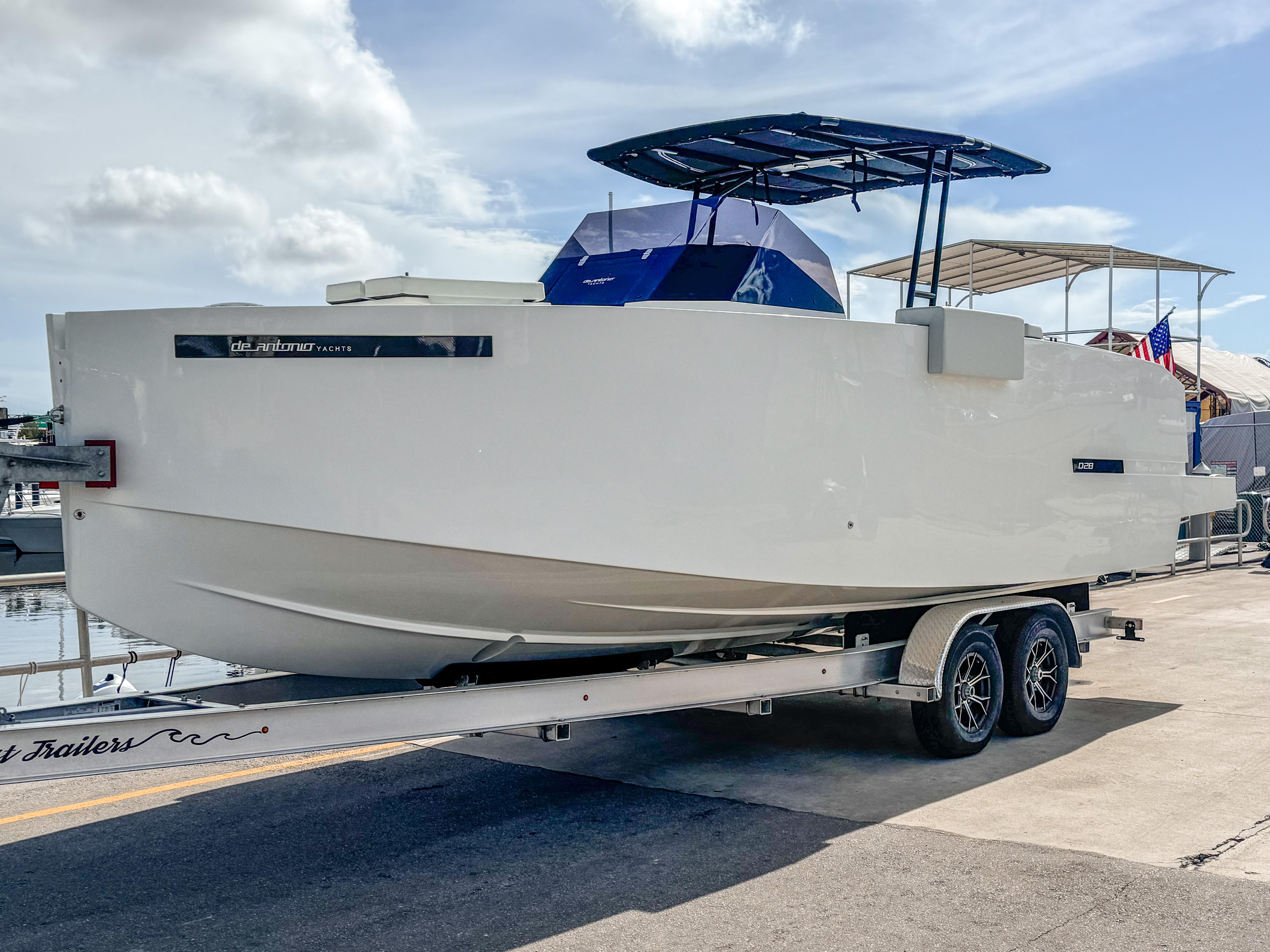 De Antonio Yachts D28 Open 2024 De Antonio Yachts D28 Open on trailer, dockside under clear sky.