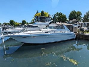Sea Ray 330 Sundancer 1996 Sea Ray 330 Sundancer docked in a marina, surrounded by calm water and trees.