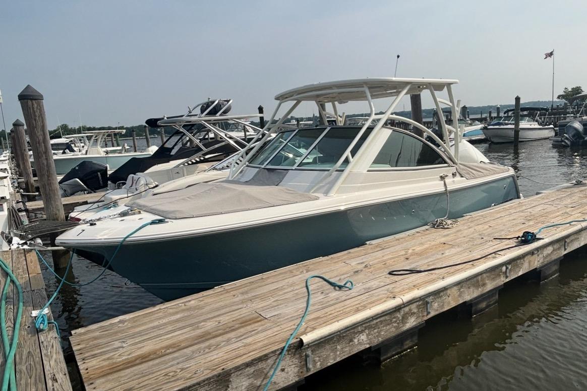Sailfish 245 DC 2025 Sailfish 245 DC boat docked at marina, featuring sleek design and modern amenities.
