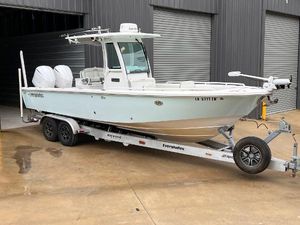 Everglades 273 Center Console 2018 Everglades 273CC boat on trailer, parked outside a warehouse.