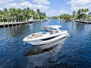 Sea Ray SLX 400 Outboard 2019 Sea Ray SLX 400 OB cruising on a scenic, palm-lined waterway.