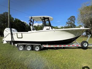 Tidewater 292 CC Adventure 2024 Tidewater 292 CC Adventure boat on trailer, parked on grass under clear blue sky.