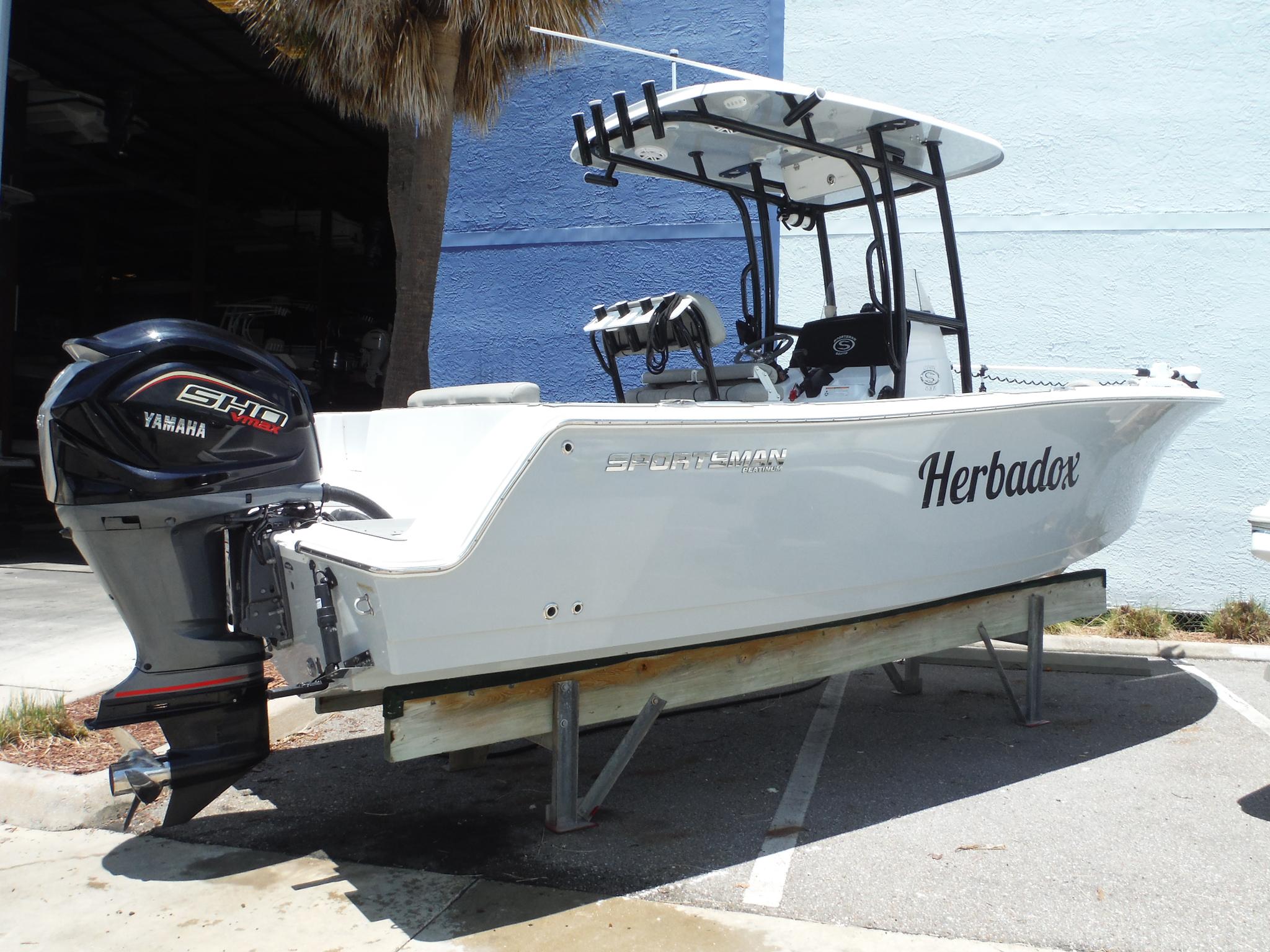 Sportsman Open 232 Center Console 2022 Sportsman Open 232 Center Console boat with Yamaha engine, parked outdoors.