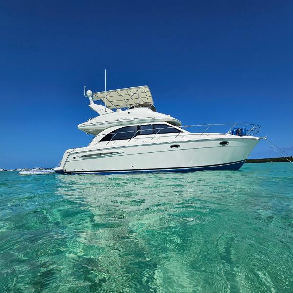 Meridian Sedan Bridge 341 2004 Meridian Sedan Bridge 341 yacht on clear turquoise water.