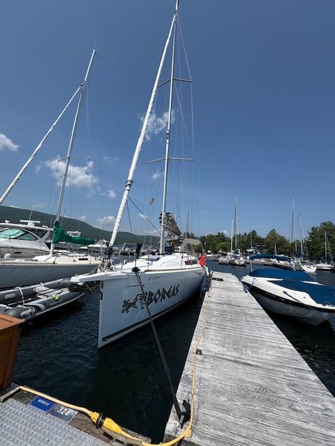 Jeanneau Sun Odyssey 389 2018 Jeanneau Sun Odyssey 389 sailboat docked at a marina under clear blue skies.