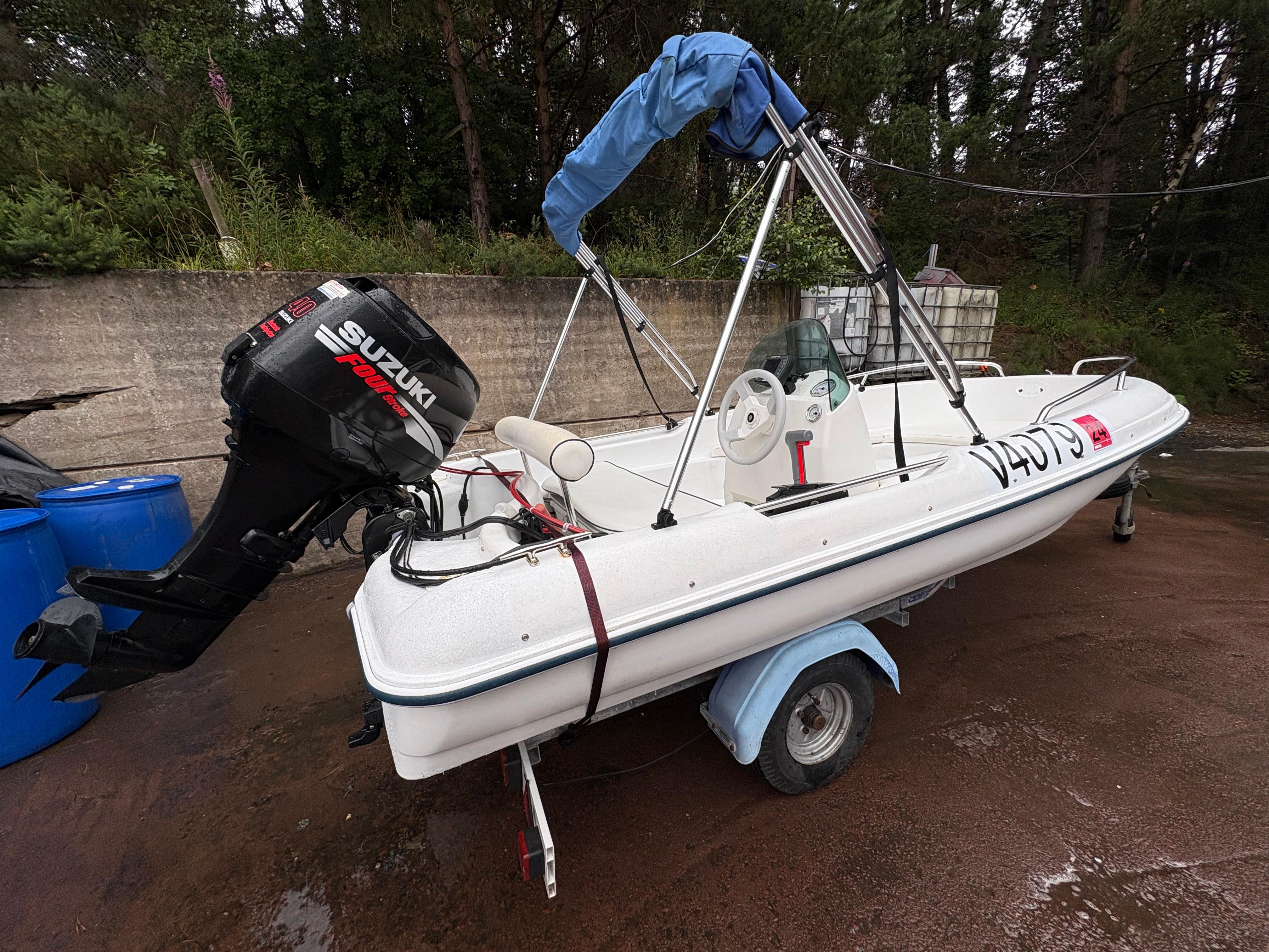 Jeanneau Rigiflex Cap 400 2009 Jeanneau Rigiflex Cap 400 boat with Suzuki outboard motor on trailer.