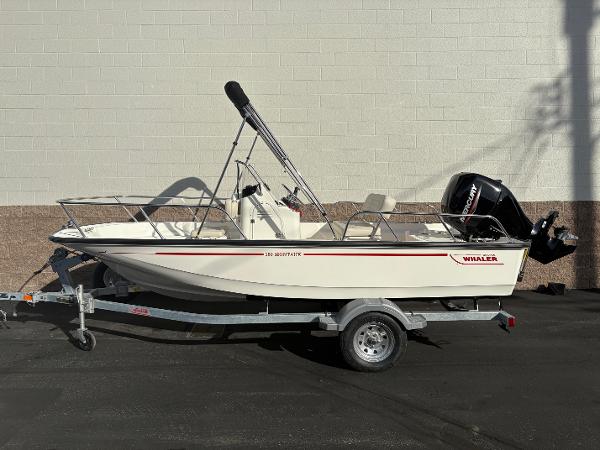 Boston Whaler 150 Montauk 2025 Boston Whaler 150 Montauk boat on trailer, side view, against a brick wall.