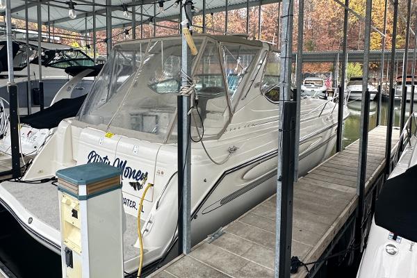 Maxum 3700 SCR 1998 Maxum 3700 SCR yacht docked in a marina under a covered slip.