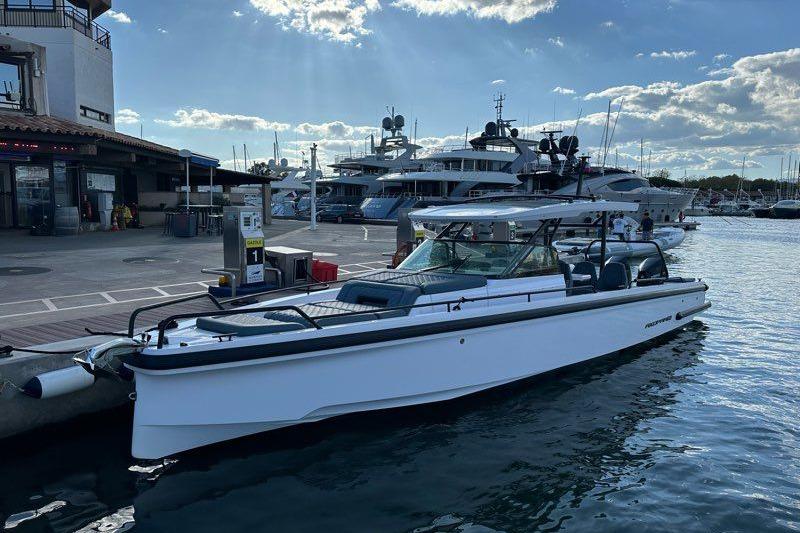 Axopar 37 SUN TOP BRABUS Line 2022 Axopar 37 SUN TOP BRABUS Line docked at a marina under a sunny sky.