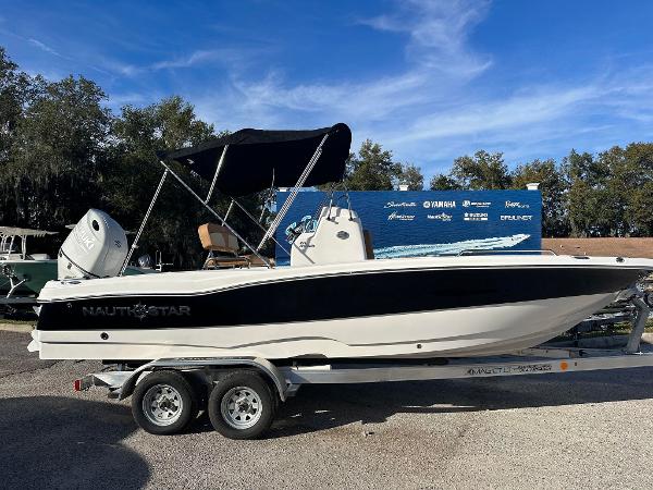 NauticStar 211 Hybrid 2024 NauticStar 211 Hybrid boat on a trailer with a black canopy.