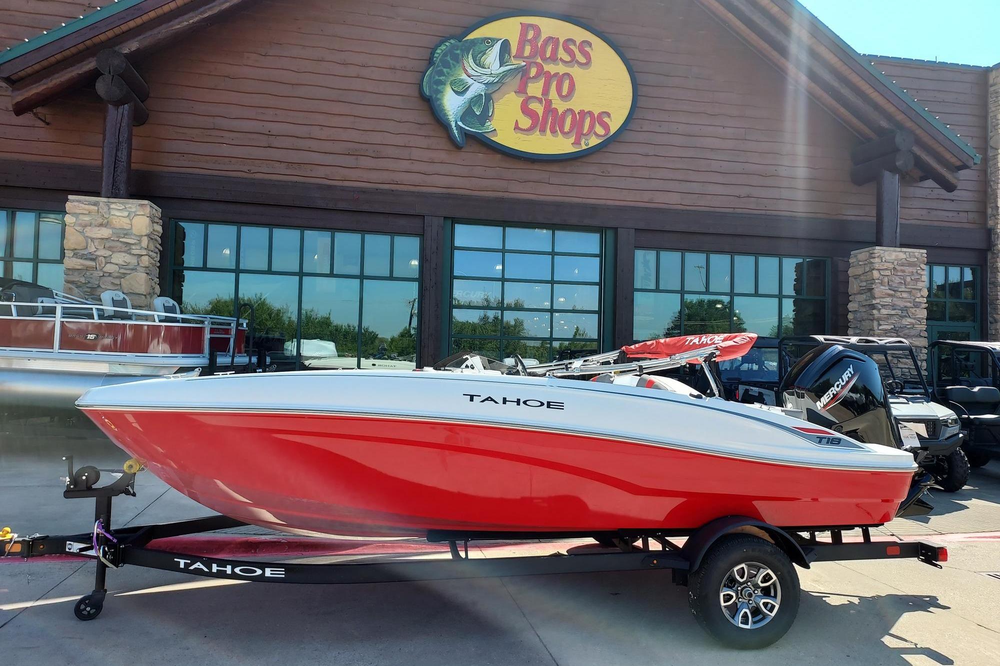 Tahoe T18 2026 Tahoe T18 boat in red, displayed outside Bass Pro Shops.