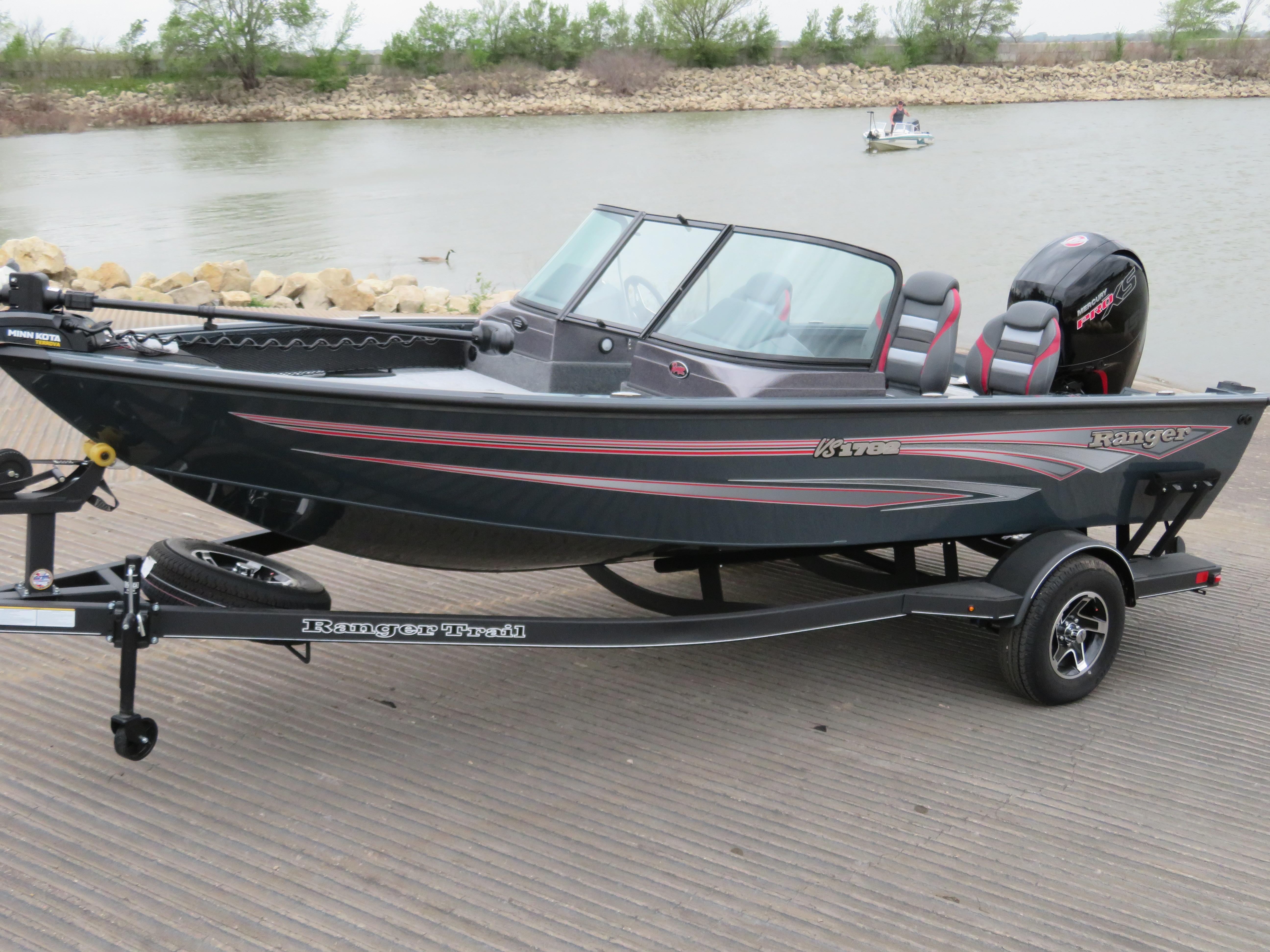 Ranger VS1782SC Angler 2024 Ranger VS1782SC Angler boat on trailer by a lake.