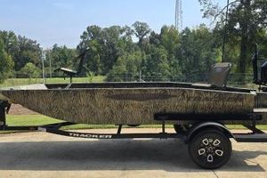 Tracker Grizzly 1650 T Prairie Wings Edition 2026 Tracker Grizzly 1650 T Prairie Wings Edition boat on trailer, camo design, outdoors.