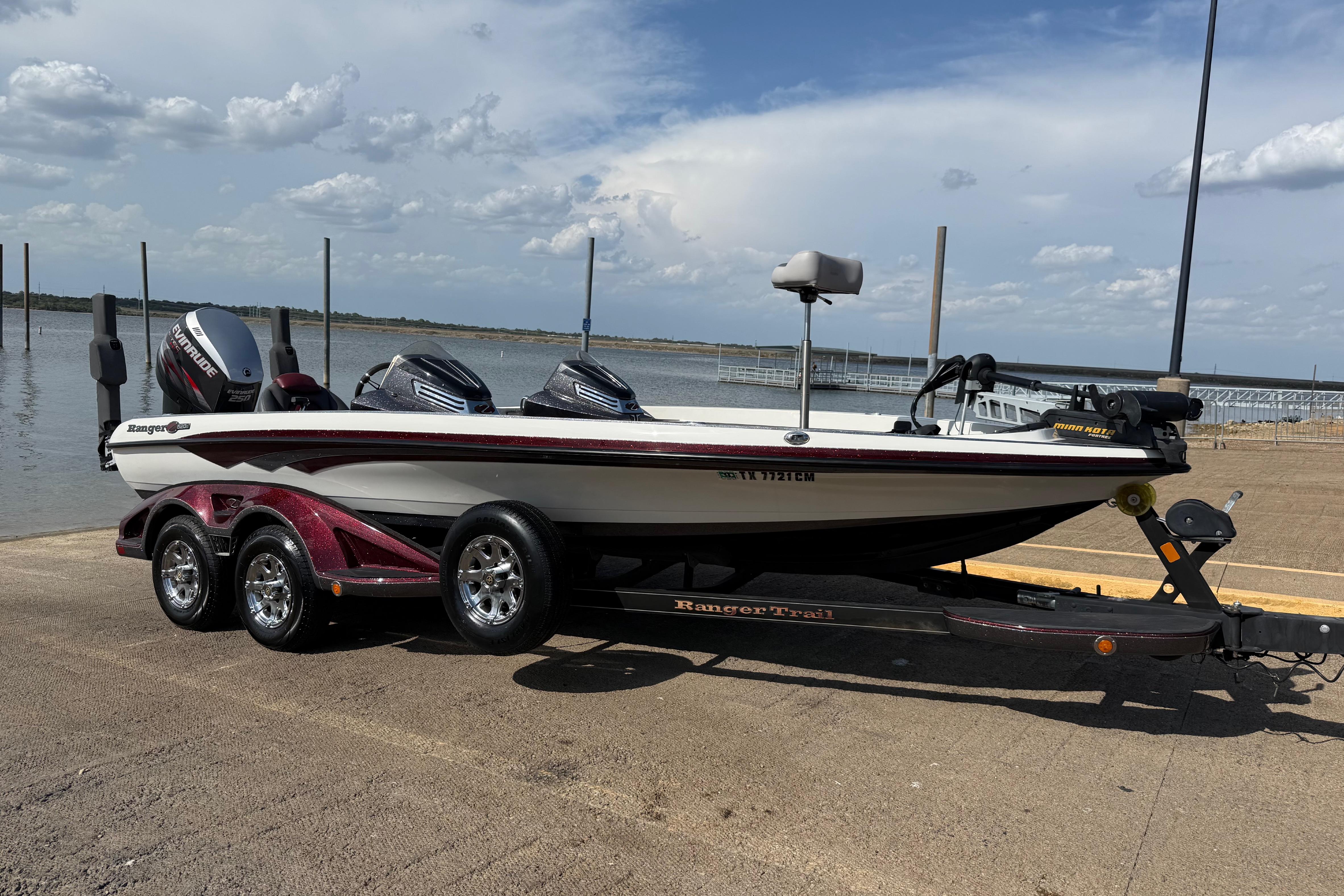 Ranger Z520 Comanche 2014 Ranger Z520 Comanche boat on trailer by a lake under a cloudy sky.