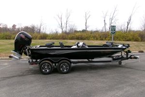 Ranger RT198P 2026 Ranger RT198P boat on trailer, parked outdoors, showcasing sleek design and powerful engine.