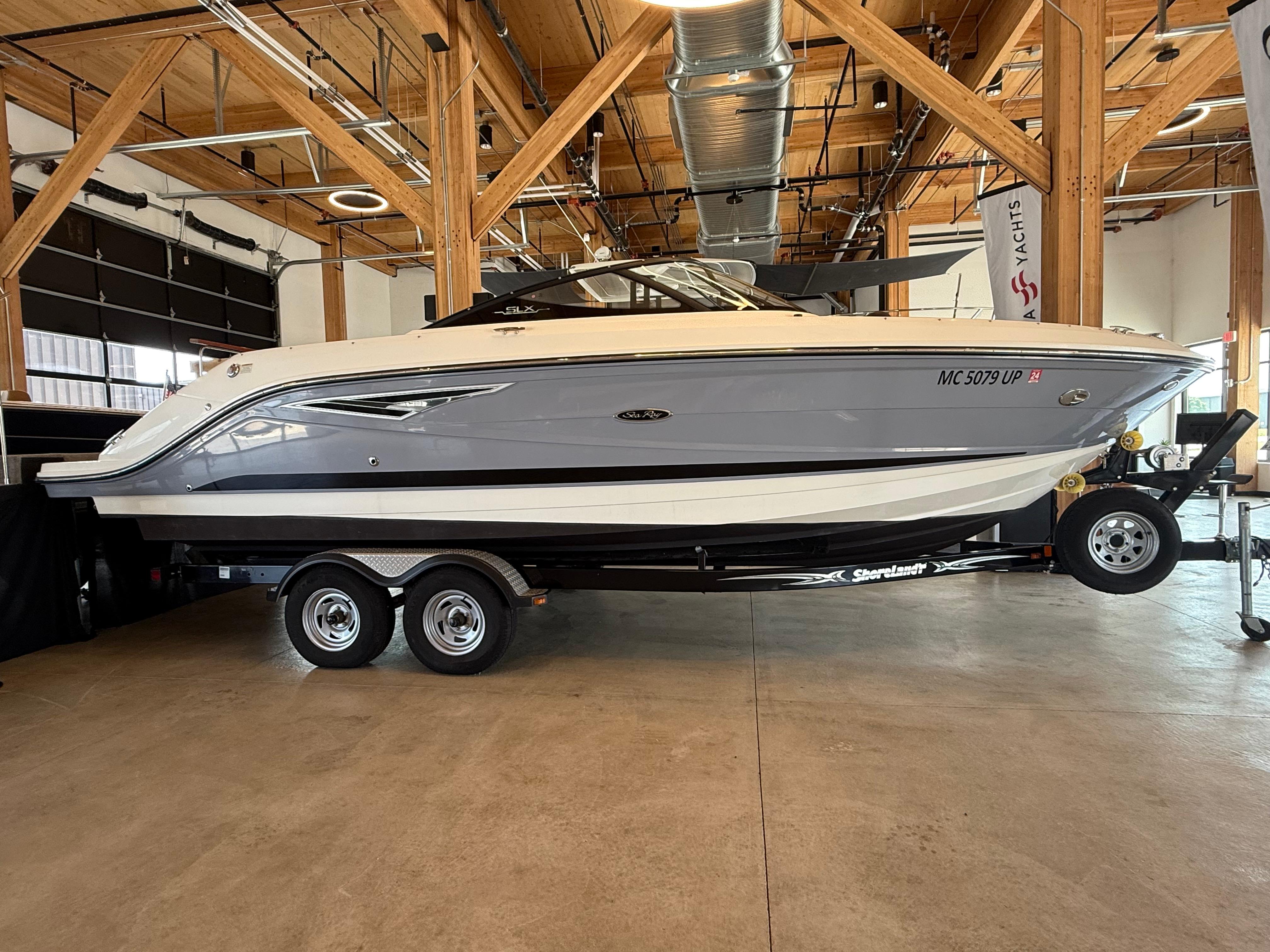 Sea Ray SLX 250 2017 Sea Ray SLX 250 boat on trailer in indoor showroom.