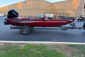 Ranger RT178 2026 Ranger RT178 boat in red, parked on a trailer in a parking lot.