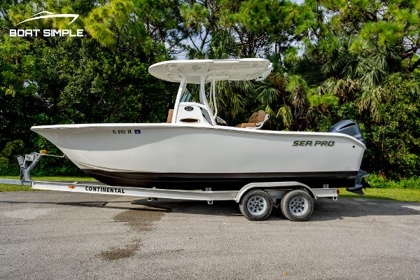 Sea Pro 239 Deep V CC 2024 Sea Pro 239 Deep V CC boat on trailer, surrounded by lush greenery.