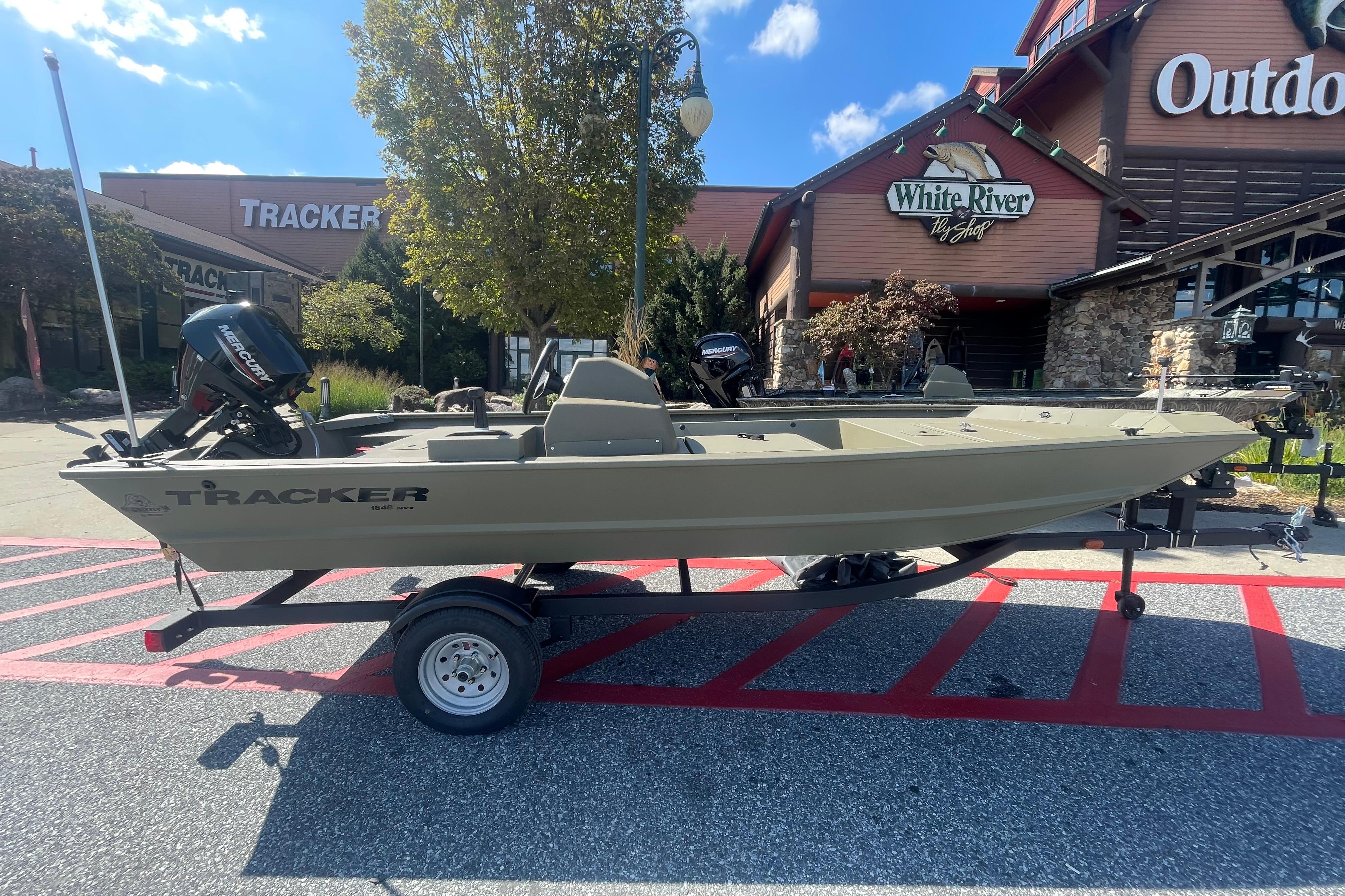 Tracker Grizzly 1648 SC 2026 Tracker Grizzly 1648 SC boat on trailer outside White River Fly Shop.