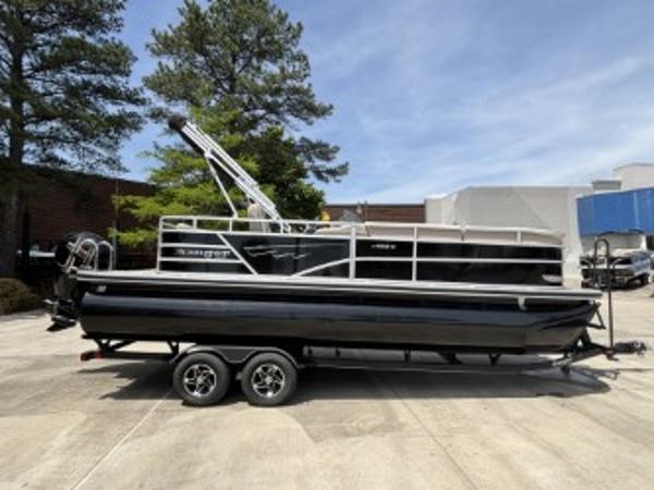 Ranger Reata 223C 2024 Ranger Reata 223C pontoon boat on trailer, parked outdoors.