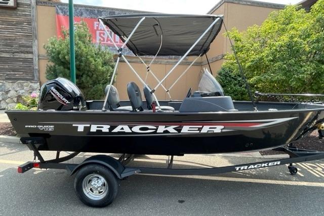 Tracker Pro Guide V-16 SC 2025 Tracker Pro Guide V-16 SC boat with canopy on trailer, outdoor setting.
