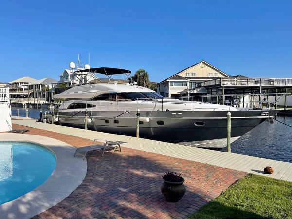 Viking Princess 65 Luxury 2003 Viking Princess 65 yacht docked by a poolside, under clear blue skies.