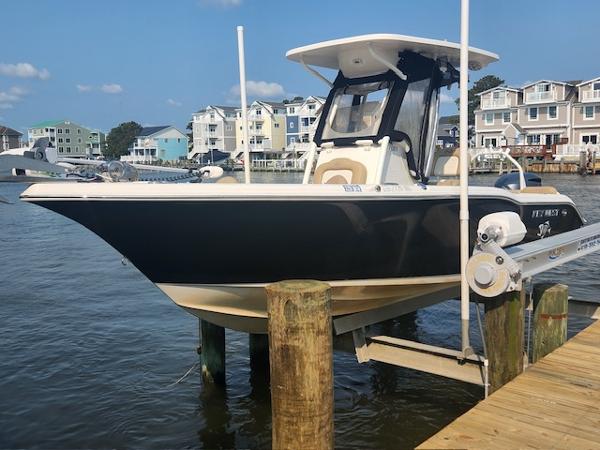 Key West 239FS Center Console 2016 Key West 239FS Center Console boat docked near waterfront homes.