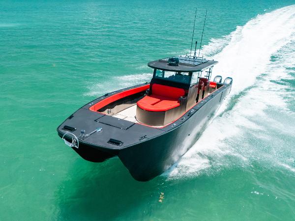 Razor Cat Razorhead 2020 Razor Cat Razorhead boat cruising on turquoise water, featuring sleek black and red design.