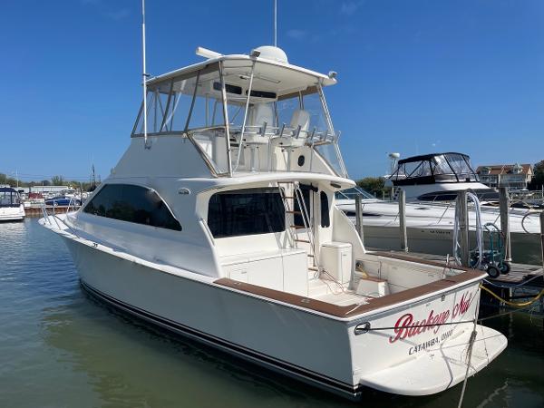 Ocean Yachts 48 Super Sport 2000 Ocean Yachts 48 Sun Sport docked at marina, clear sky background.