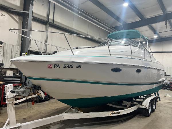 Chris-Craft Crowne 262 1994 Chris-Craft 262 Crowne boat on trailer in indoor storage facility.