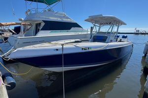Donzi 32 ZF Open 2008 Donzi 32 ZF Open boat docked at marina under clear blue sky.