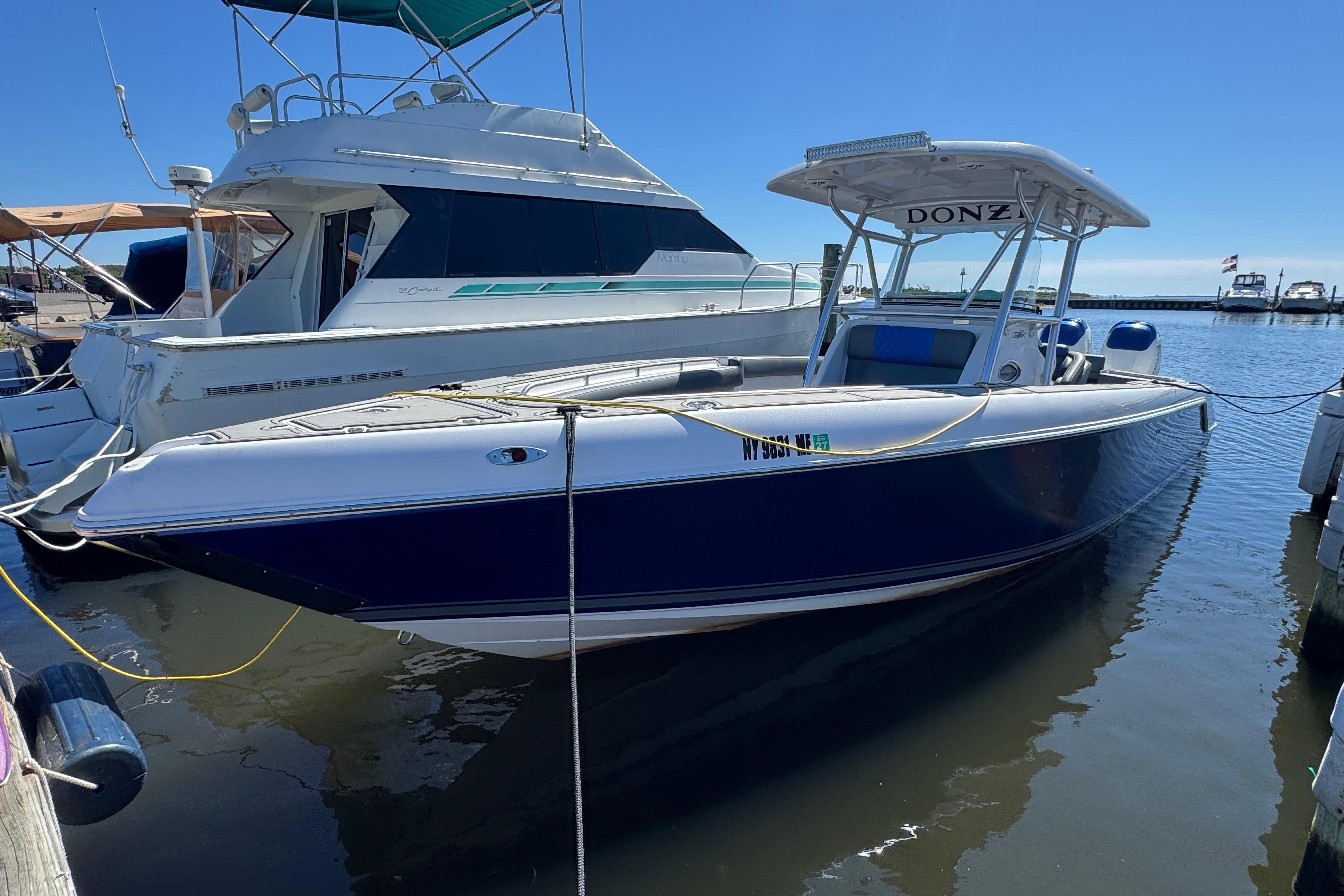 Donzi 32 ZF Open 2008 Donzi 32 ZF Open boat docked at marina under clear blue sky.