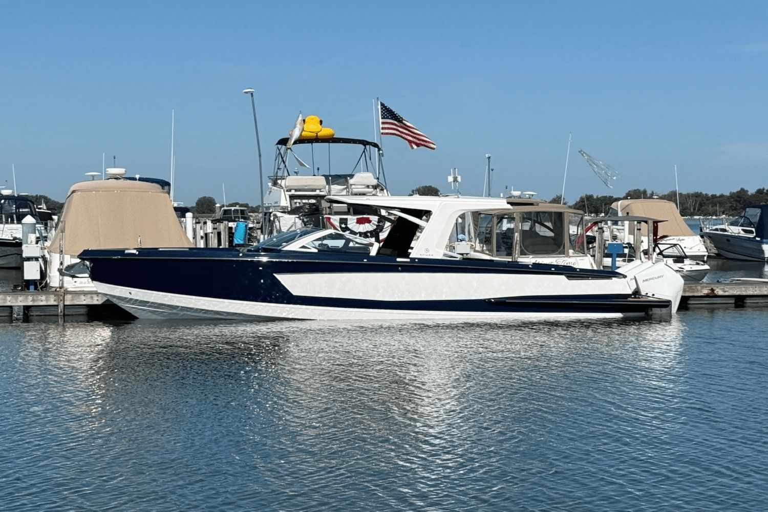 Aviara AV36 Outboard 2023 Aviara AV36 Outboard boat docked at marina, American flag waving.