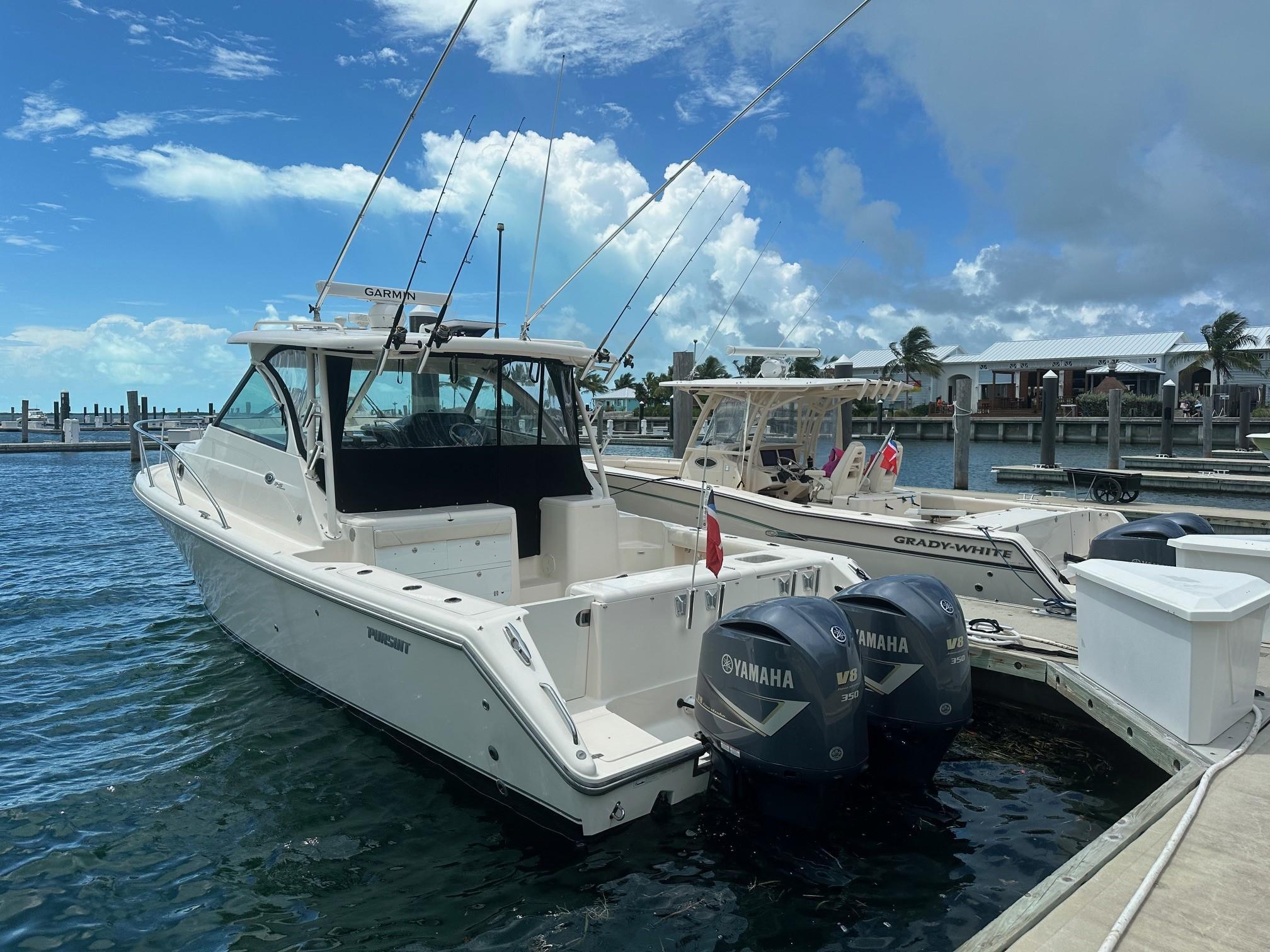 Pursuit OS 345 Offshore 2012 Pursuit OS 345 Offshore boat docked with Yamaha engines, under a partly cloudy sky.