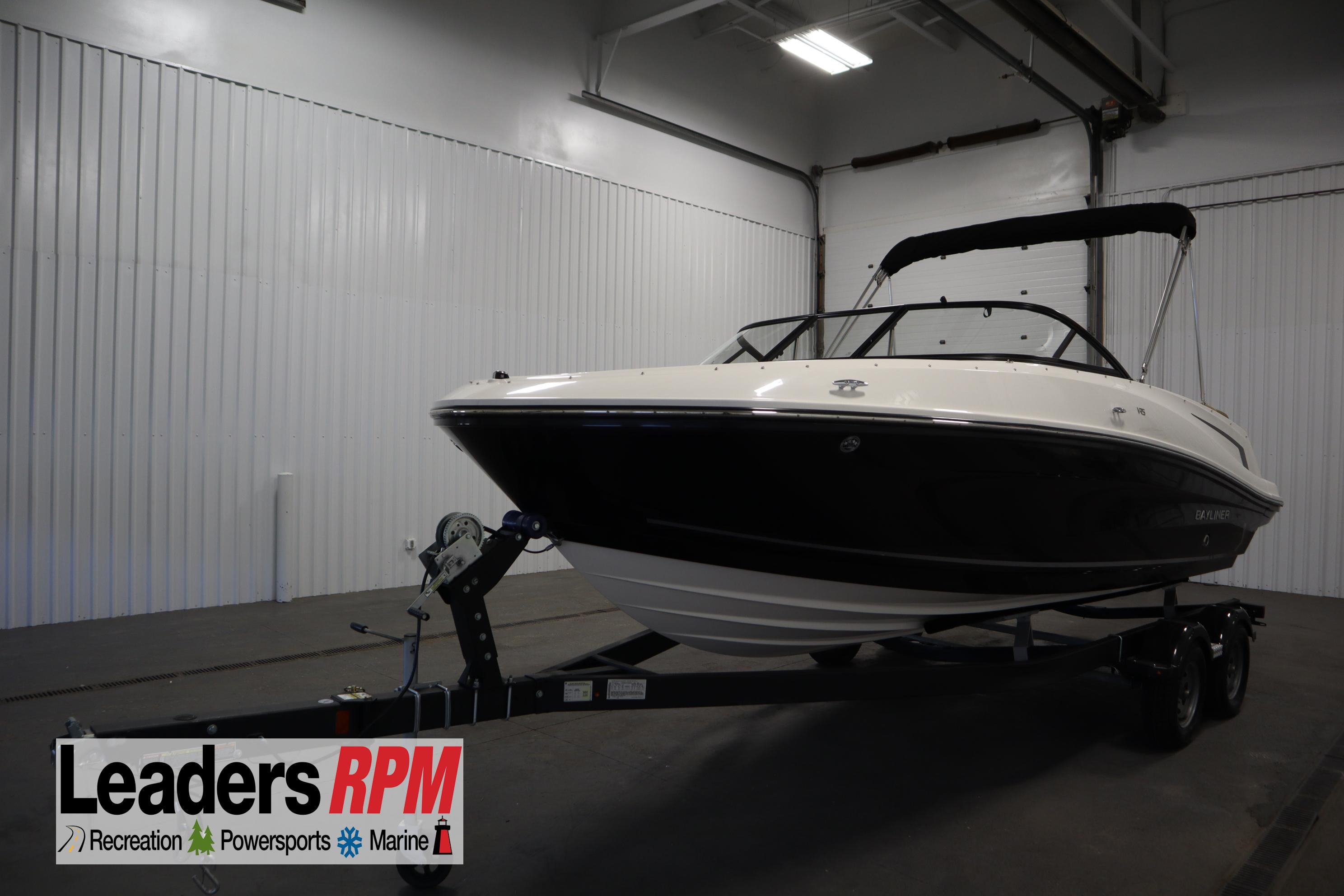 Bayliner VR5 Bowrider 2024 Bayliner VR5 Bowrider boat on trailer in indoor showroom.