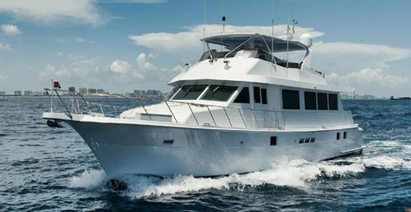 Hatteras 74 Cockpit Motor Yacht 1998 Hatteras 74 Cockpit Motor Yacht cruising on open water under a clear sky.