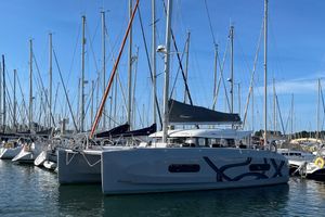 Excess EXCESS 11 2023 Excess EXCESS 11 catamaran docked in a marina with clear blue skies.