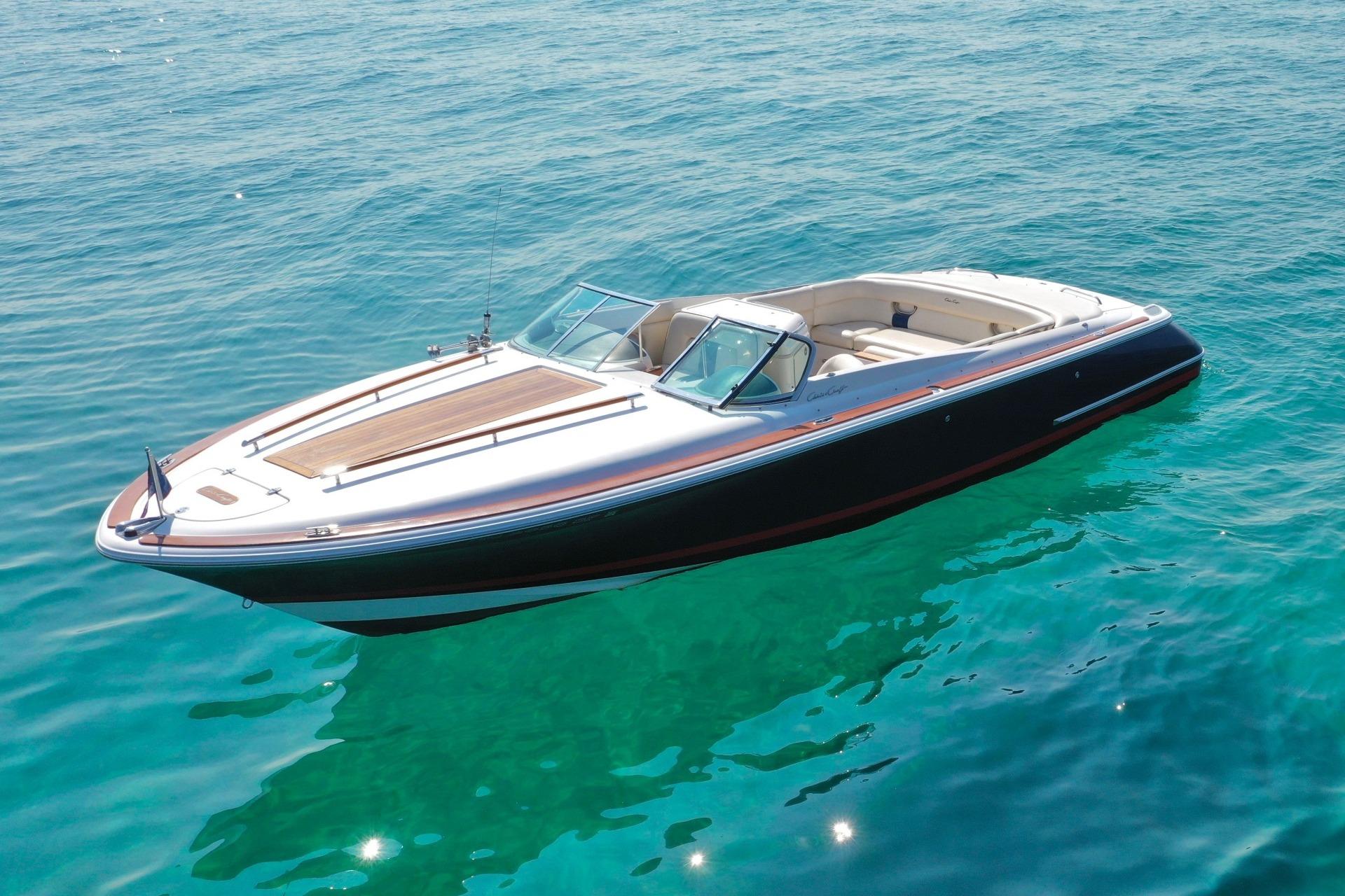 Chris-Craft Corsair 28 2003 Chris-Craft Corsair 28 boat on clear blue water, showcasing sleek design and luxury.
