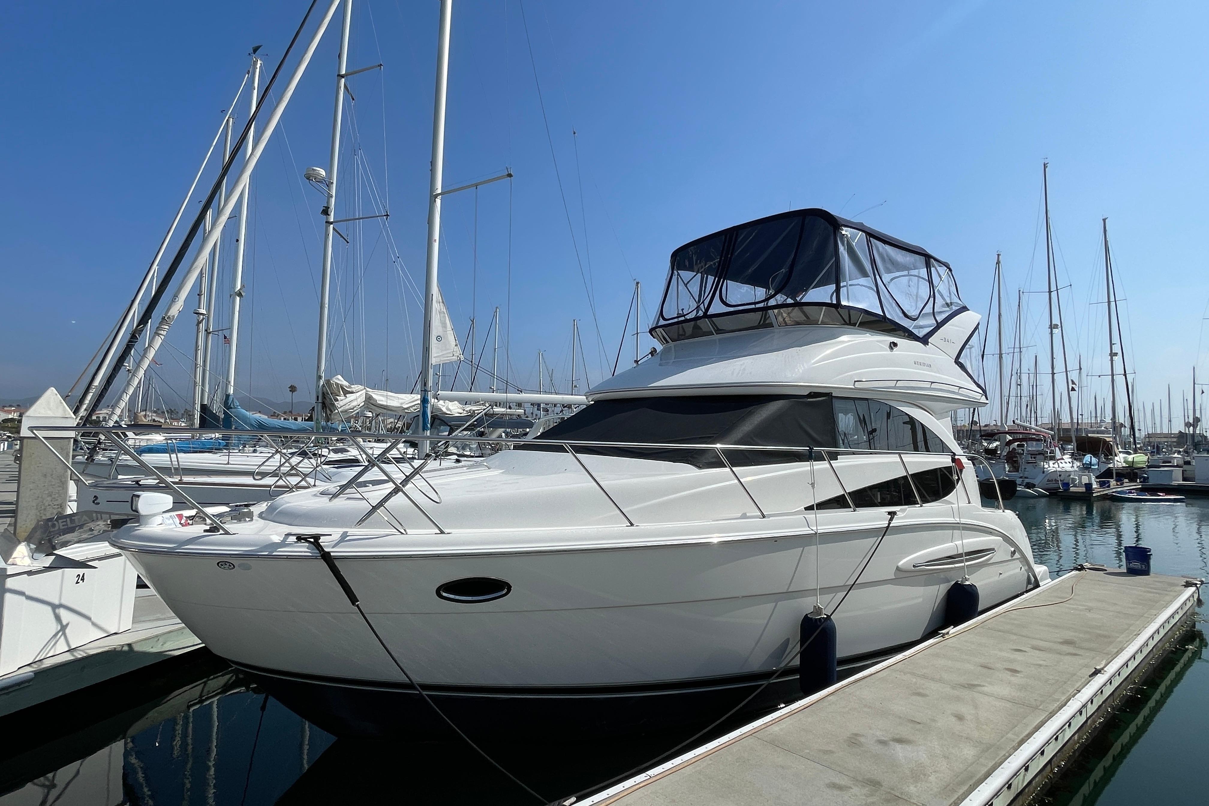 Meridian 341 Sedan 2008 Meridian 341 Sedan yacht docked at marina under clear blue sky.