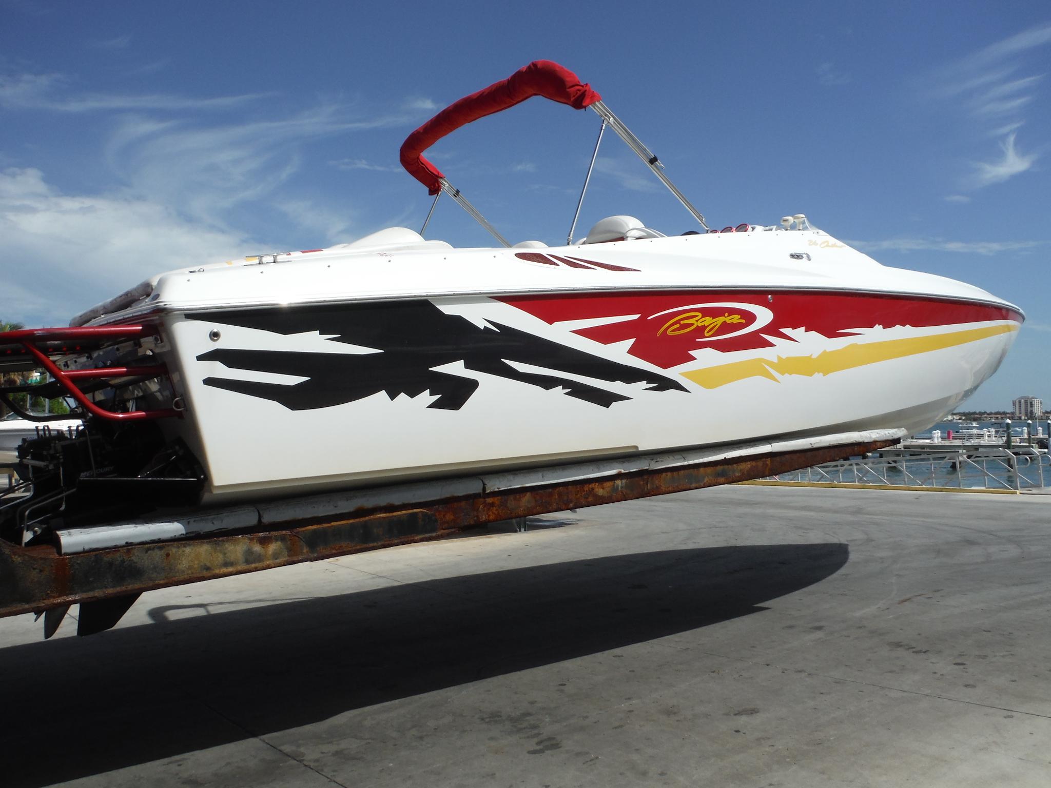 Baja 36 Outlaw 2003 Baja 36 Outlaw speedboat with vibrant graphics on a trailer.