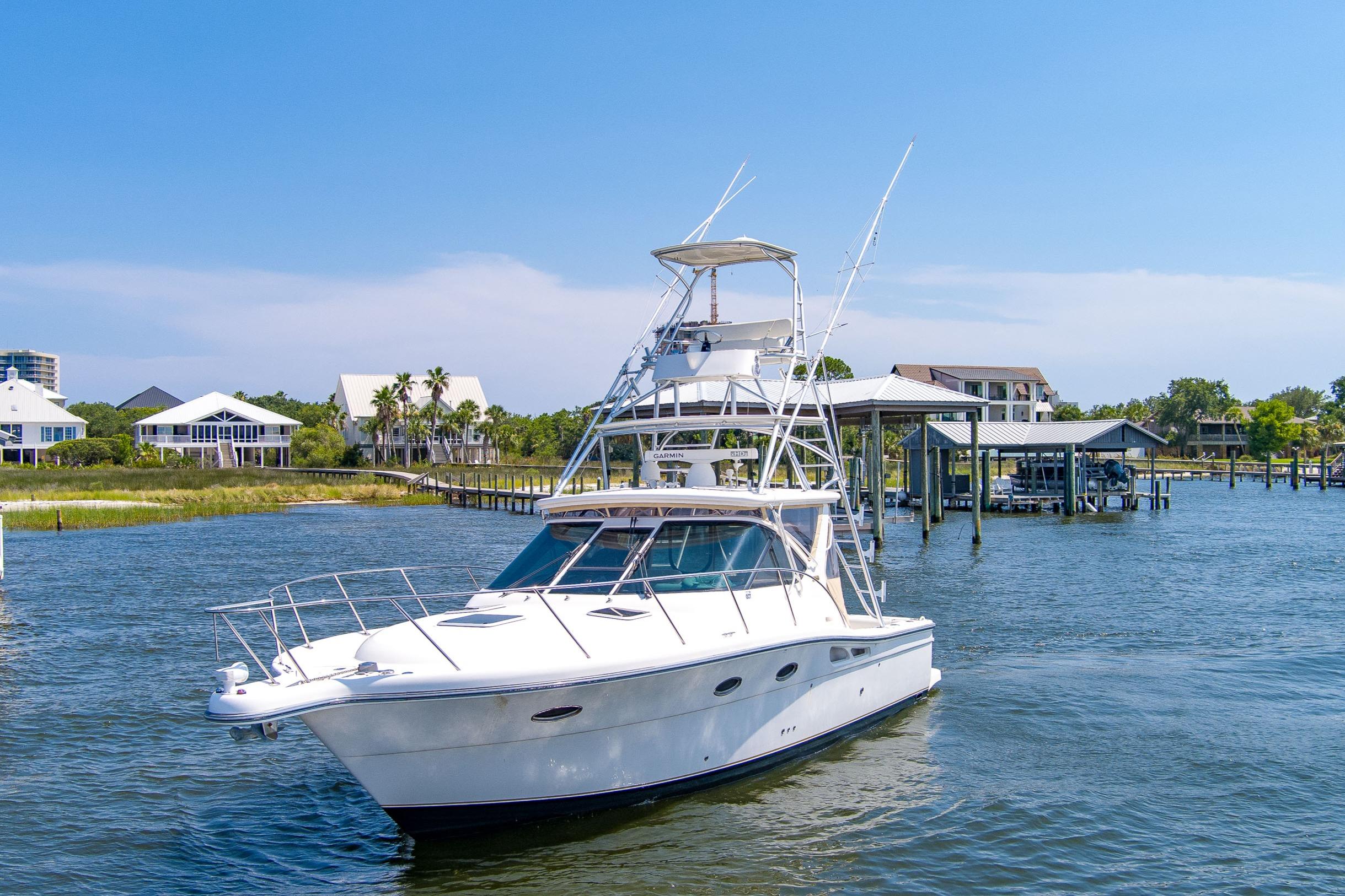 Tiara Yachts Sport Fish 2008 Tiara Sport Fish boat on water near docks and waterfront homes.
