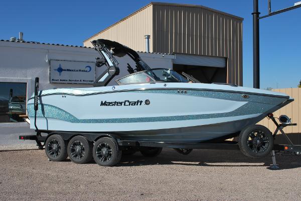 MasterCraft X24 2022 MasterCraft X24 boat on trailer outside a building.