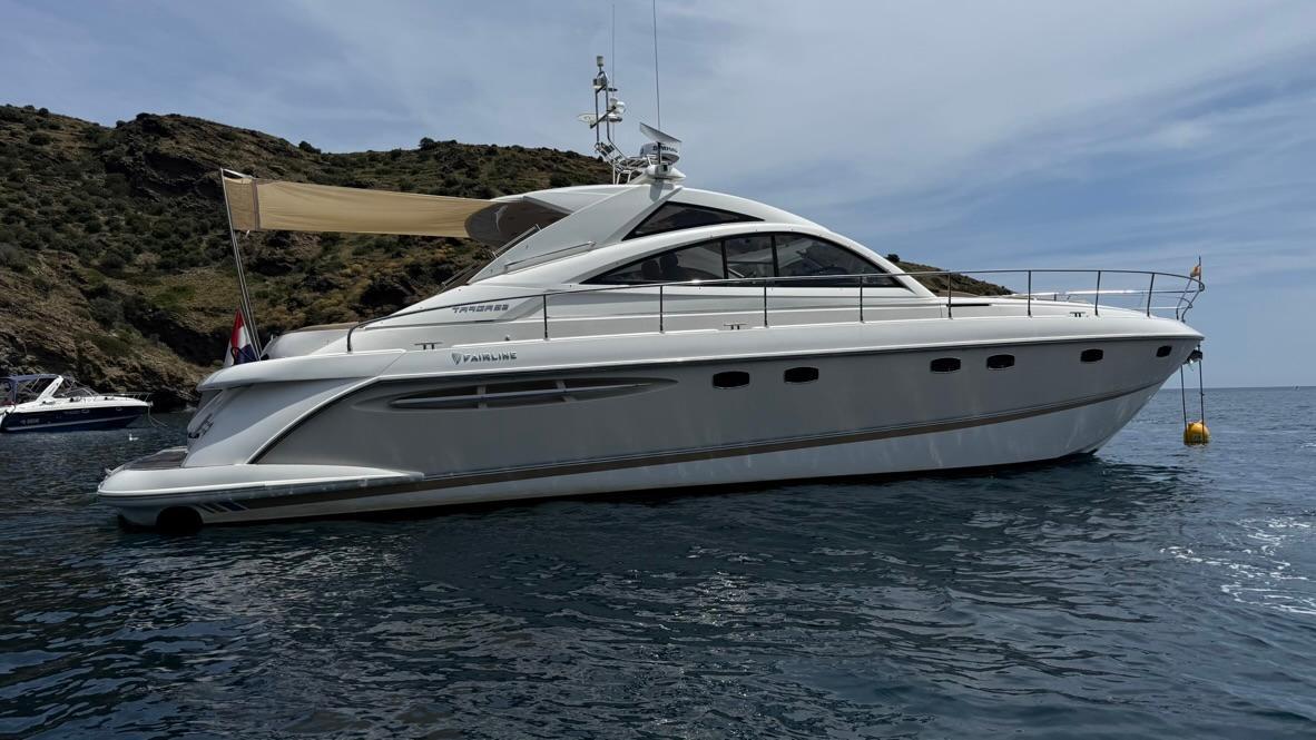 Fairline Targa 52 GT MK3 2009 Fairline Targa 52 GT MK3 yacht anchored near rocky coastline.
