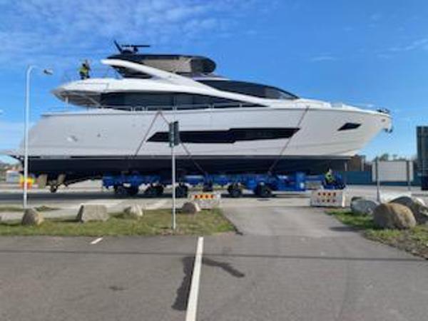 Sunseeker 86 2018 Sunseeker 86 yacht on transport trailer under clear blue sky.