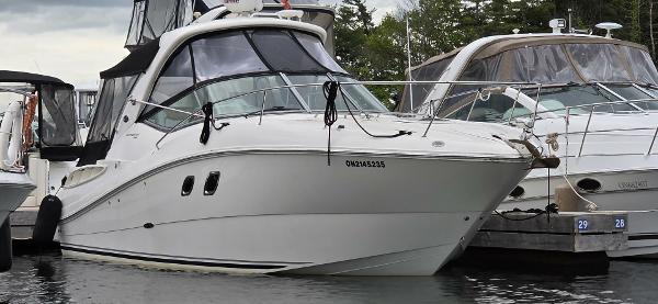 Sea Ray 310 Sundancer 2009 Sea Ray 310 Sundancer docked at marina, side view.
