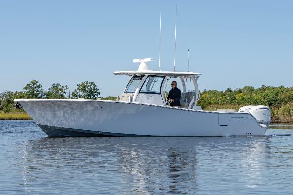 Sportsman Open 322 Center Console 2025 Sportsman Open 322 Center Console boat on calm water, side view.