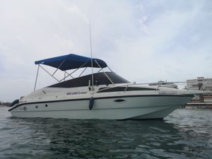 RIO Cruiser 650 1995 RIO Cruiser 650 boat with blue canopy on calm water.